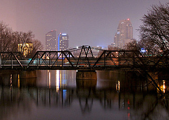 Amtrack with Grand Rapids in Background<br>Photo: <a href="https://commons.wikimedia.org/wiki/File:Amtrak_under_the_skyline_(4435232885).jpg">Russell Sekeet</a>, <a href="https://creativecommons.org/licenses/by/2.0">CC BY 2.0</a>, via Wikimedia Commons